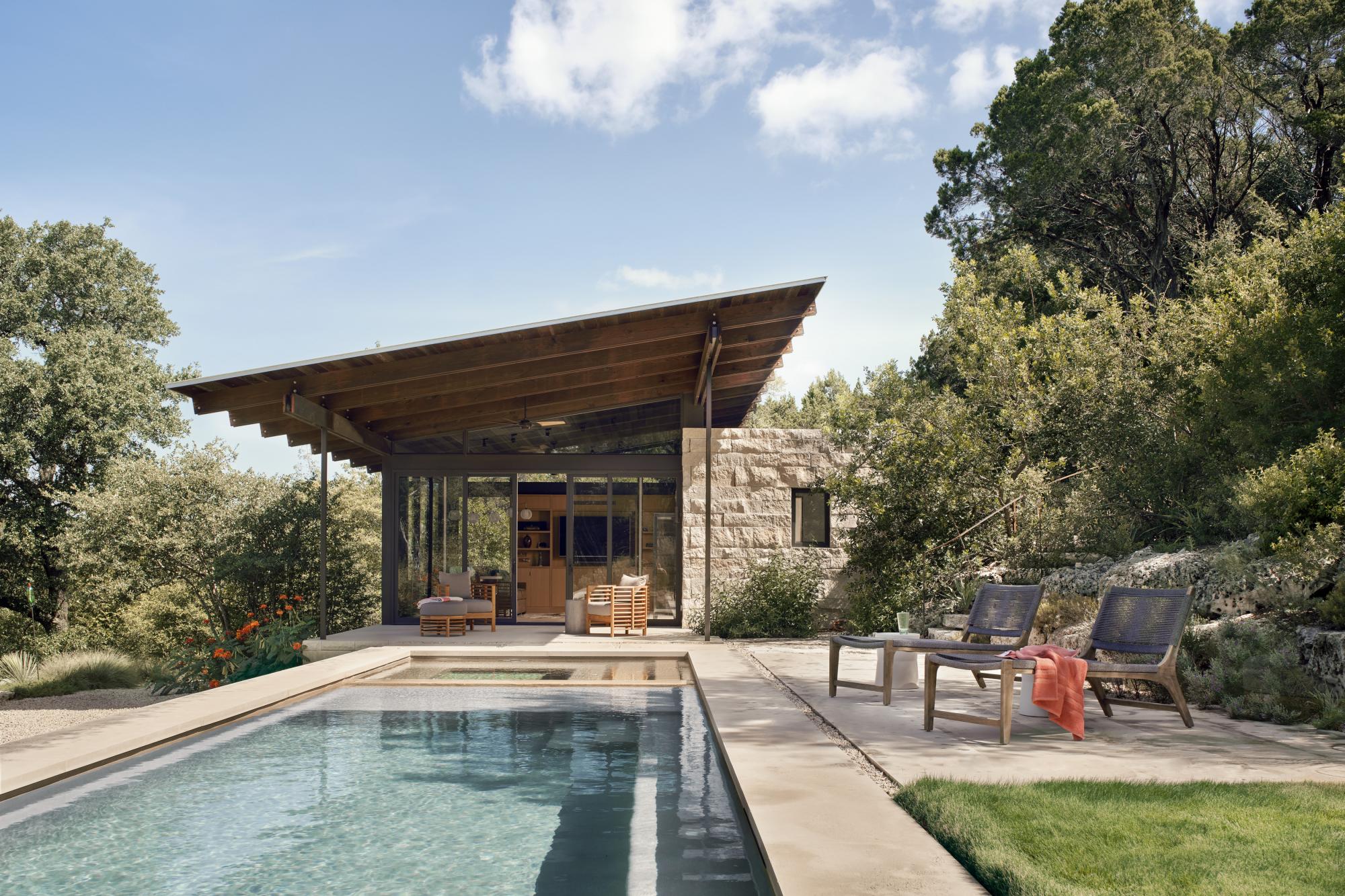 The linear plans of the pool house are comprised of a simple stone “box” of rooms that anchor the structures to the hillside