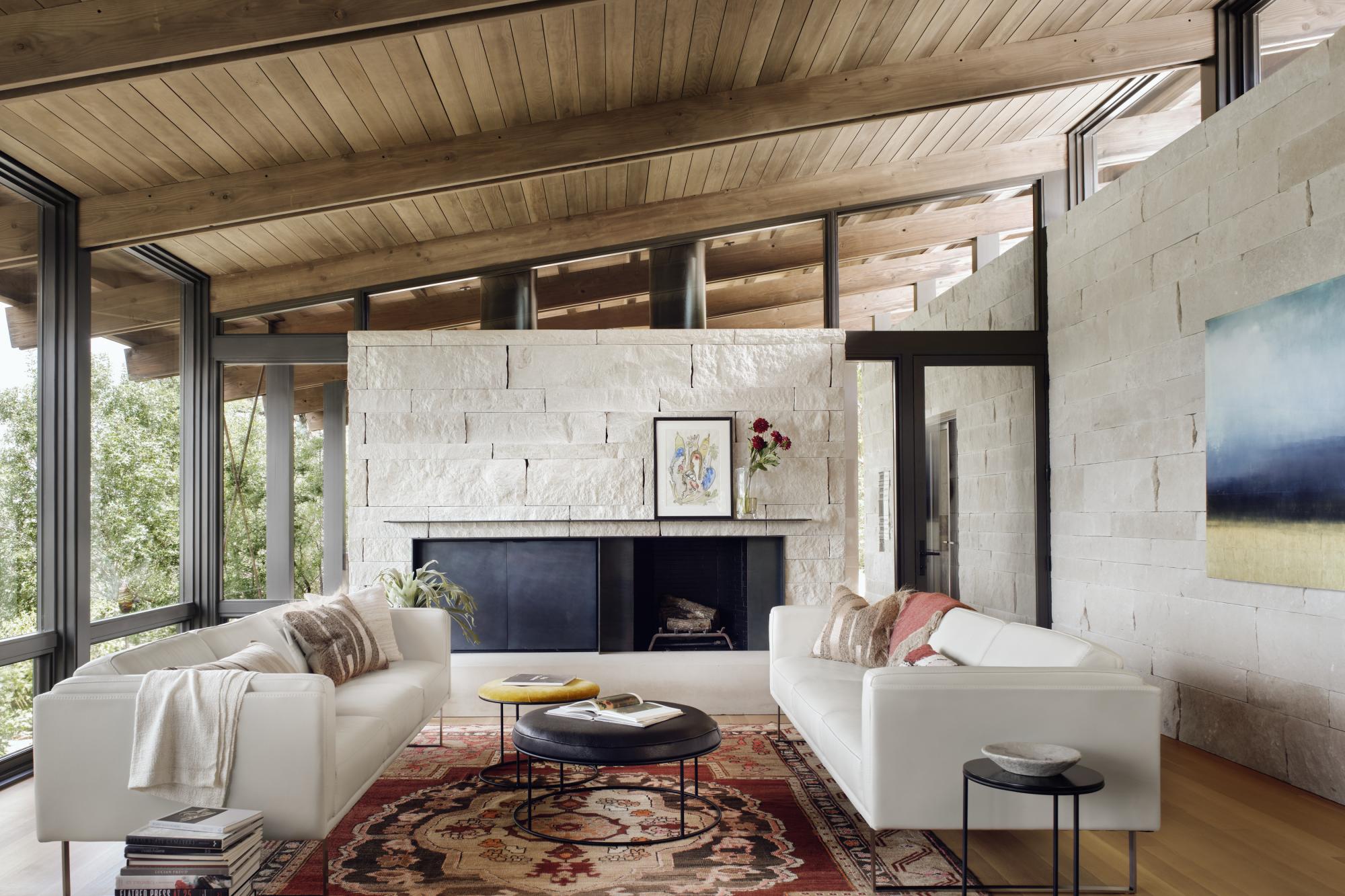 The linear plans of the main house are comprised of a simple stone “box” of rooms that anchor the structures to the hillside, living room is connected to the landscape.