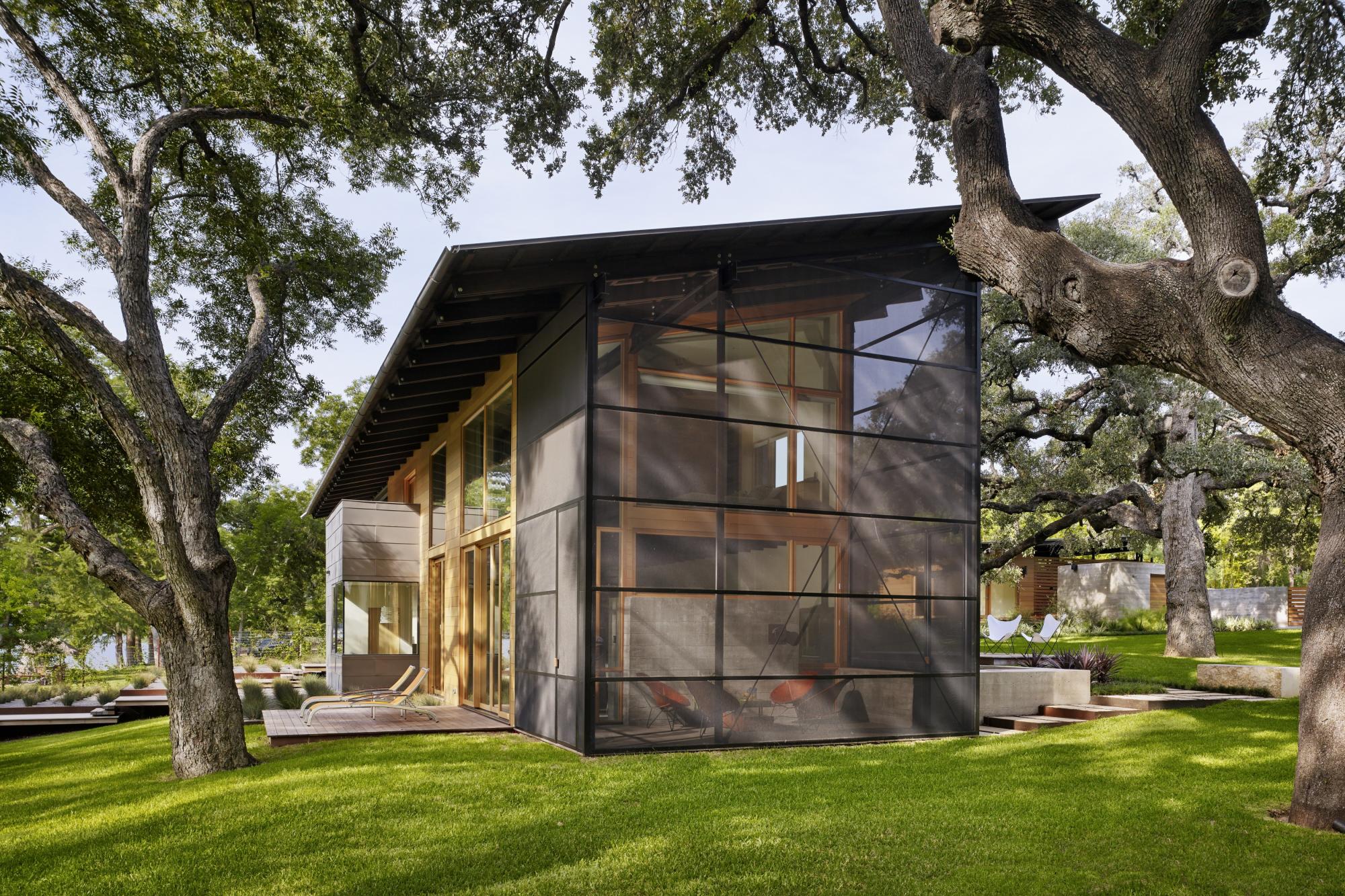 Situated at the confluence of Hog Pen Creek and Lake Austin, Hog Pen Creek Residence was envisioned by its owners as a place that evokes the playfulness of summer on the lake. Twin porches and a two-story living area, with a treetop level master bedroom l