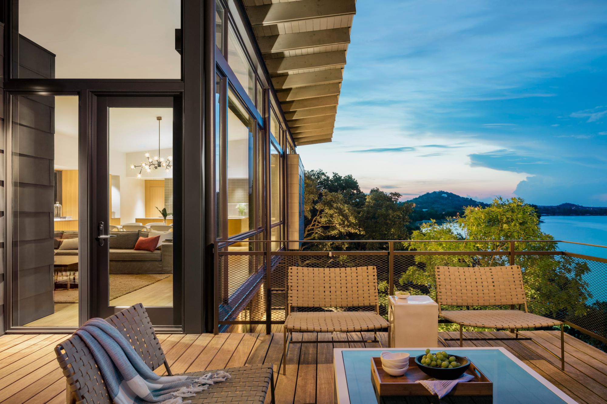 Blue Lake Retreat third floor’s cantilevered deck reaches toward the water, All circulation space was shifted outdoors, allowing further immersion in nature 