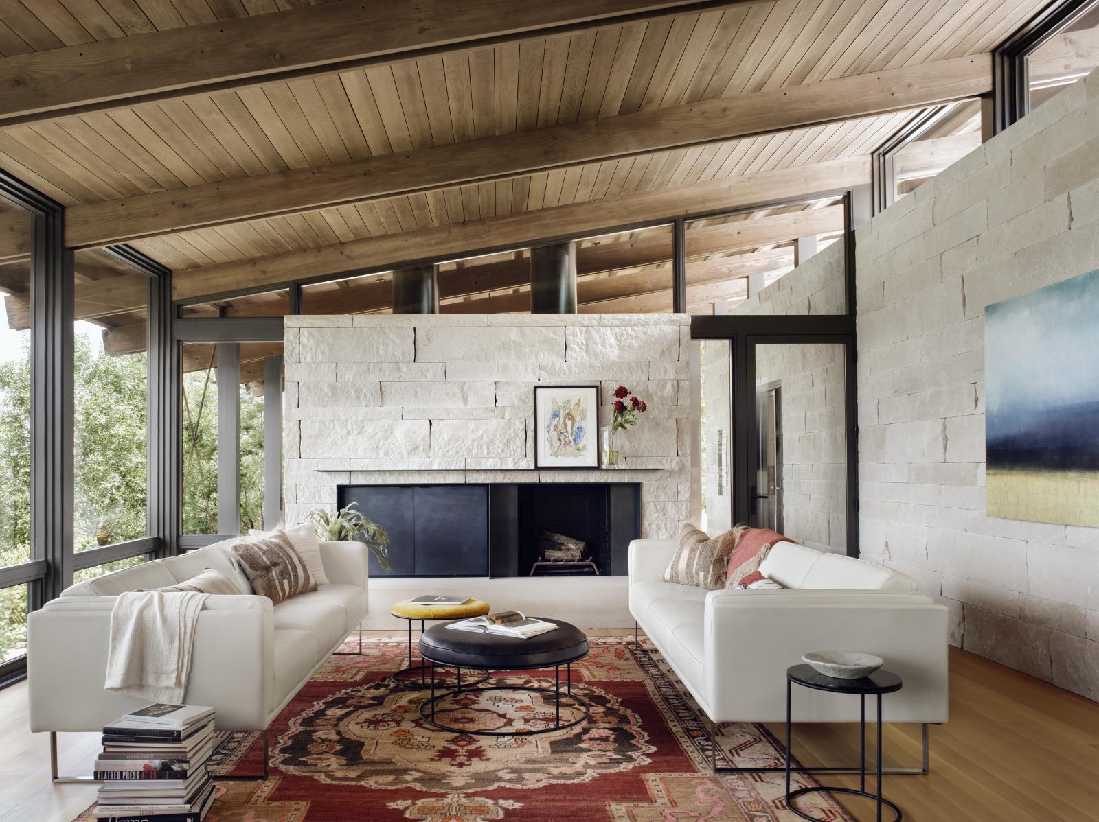 The linear plans of the main house are comprised of a simple stone “box” of rooms that anchor the structures to the hillside, living room is connected to the landscape.