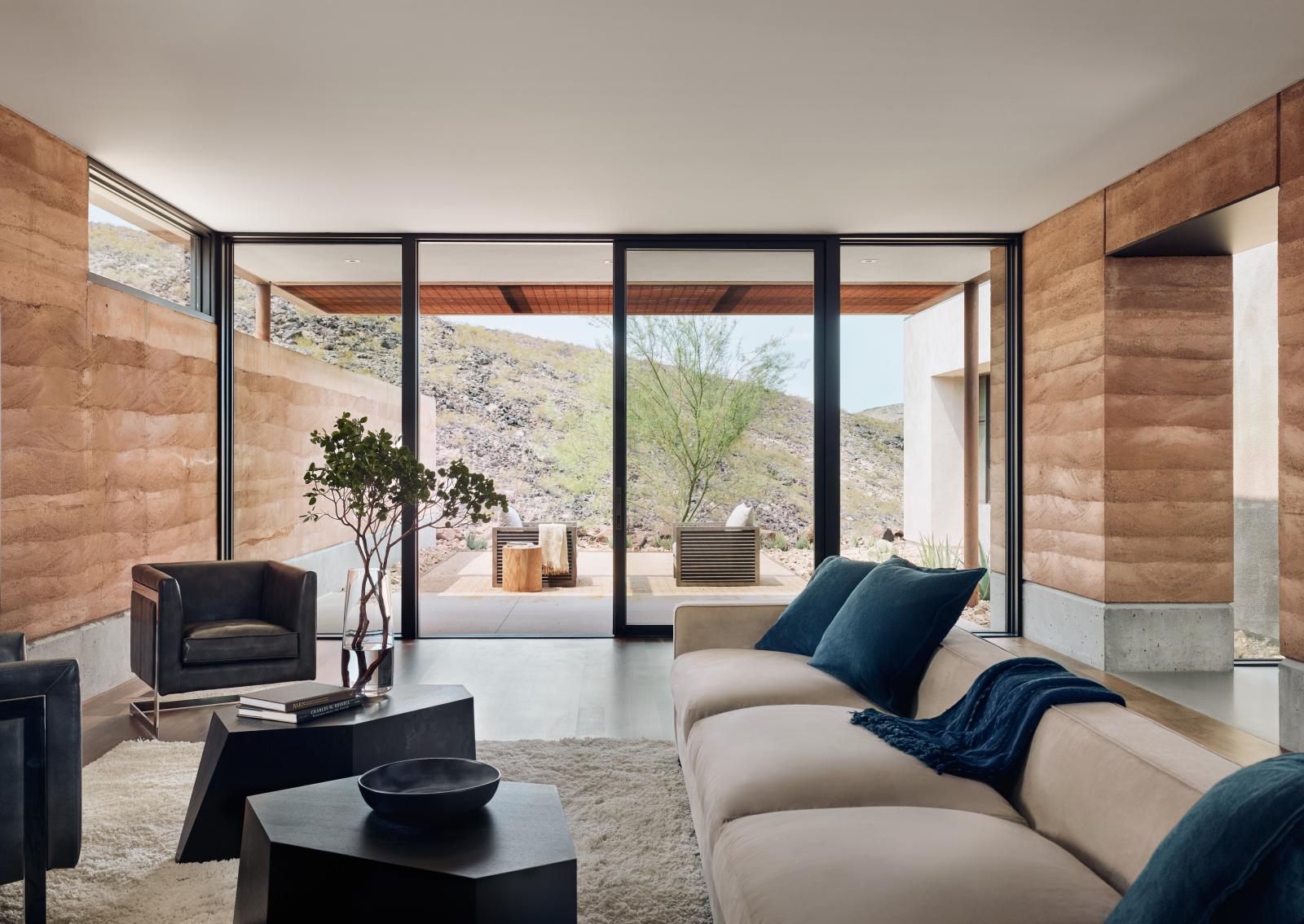 Rammed earth walls in living room, with views facing courtyard The rammed earth textures, colors and materials blend seamlessly with the surrounding desert.