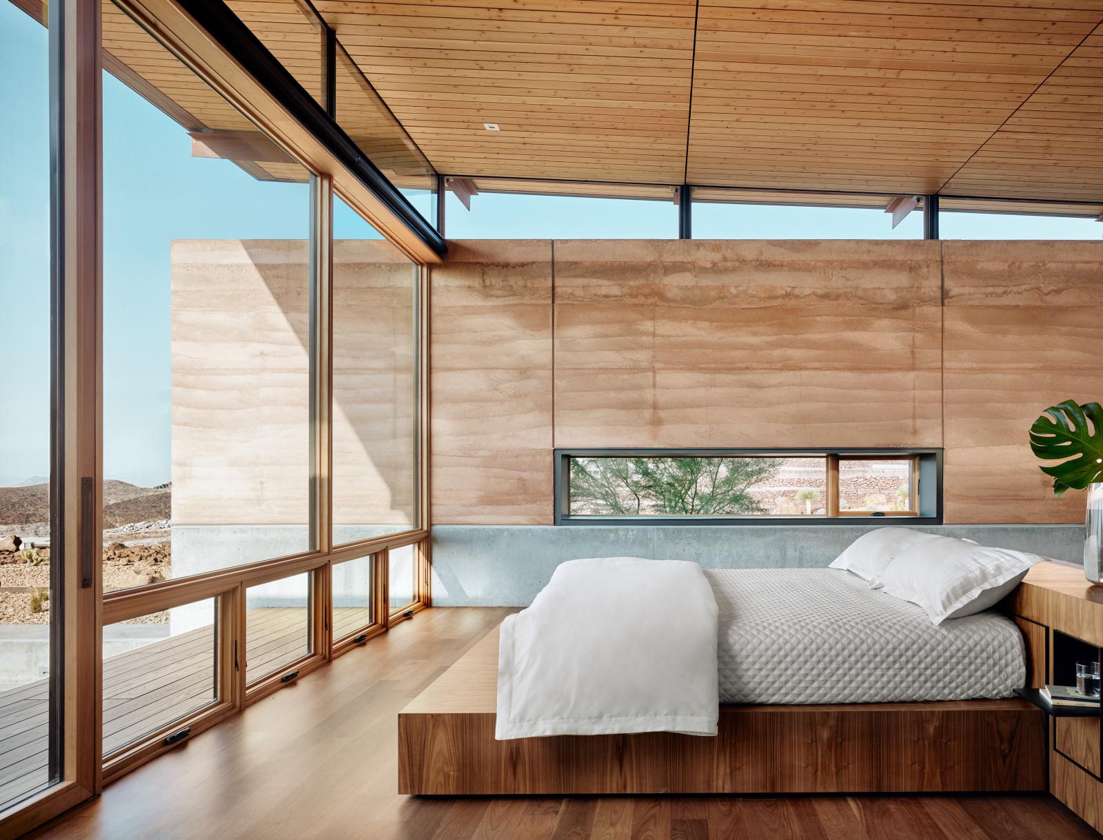 The rammed earth used to create the earthen walls, resulted in a warm, natural material for the master bedroom. A blend of two local soils was used to create the earthen walls, resulting in a warm, natural material that defines the home’s identity