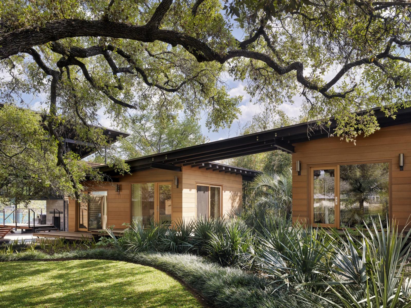 Towering heritage oak trees shade the front lawn and separate  guest quarters