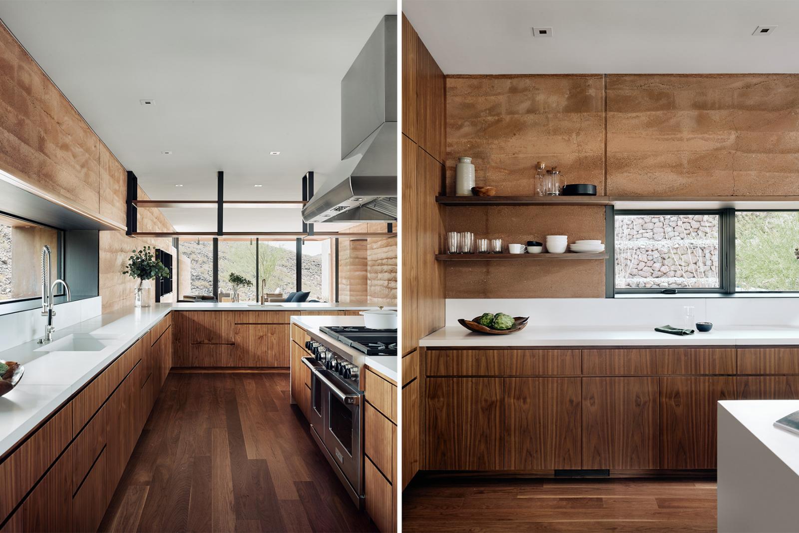 Two kitchen views, boast of rammed earth walls, wood clad cabinetry and large windows with views to desert. Interior kitchen views, boast of rammed earth walls, wood clad cabinetry and large windows with views to desert.