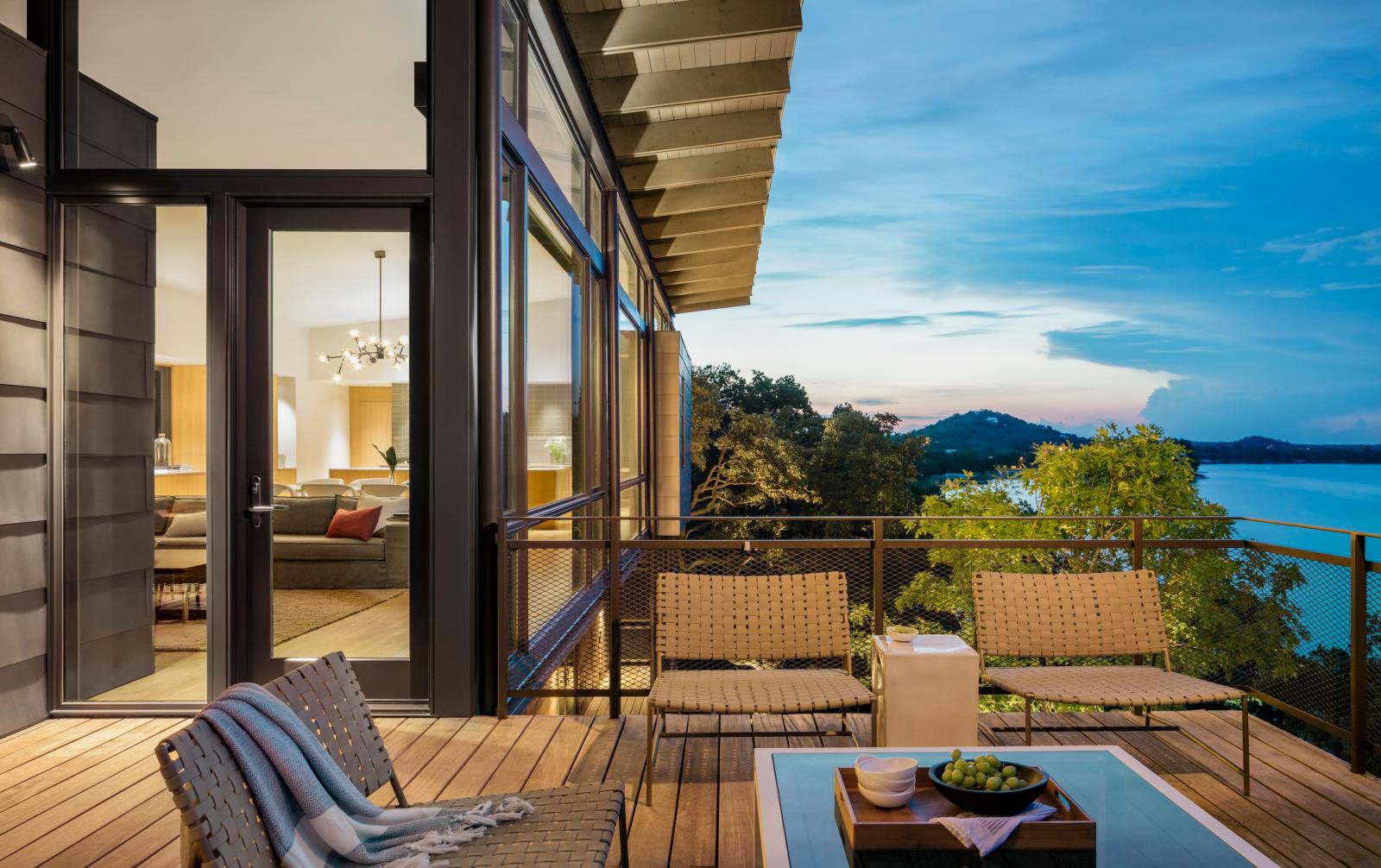 Evening sunset from 3rd floor sky porch Blue Lake Retreat third floor’s cantilevered deck reaches toward the water, All circulation space was shifted outdoors, allowing further immersion in nature